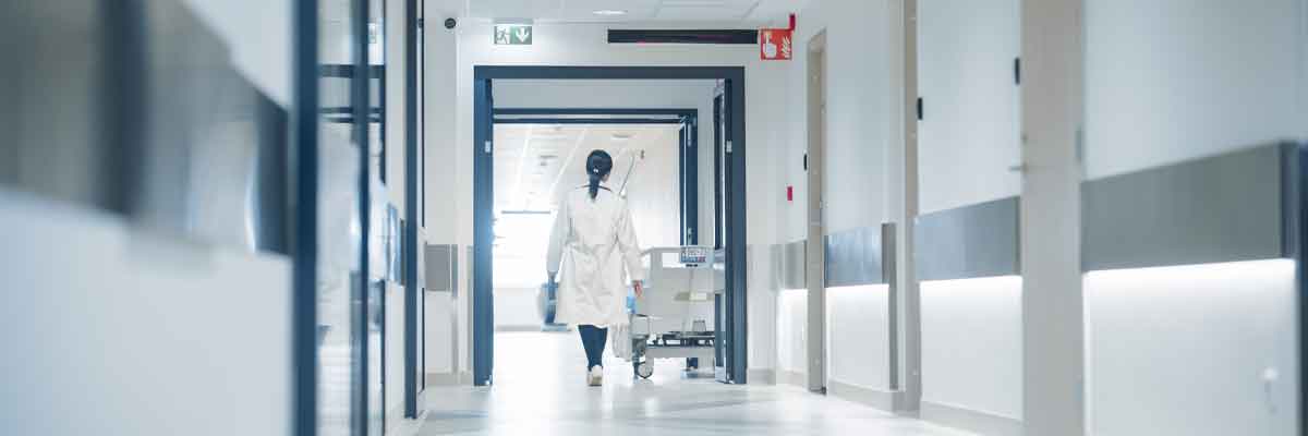 Healthcare Key Safe Hallway in hospital with a female doctor and a gurney.