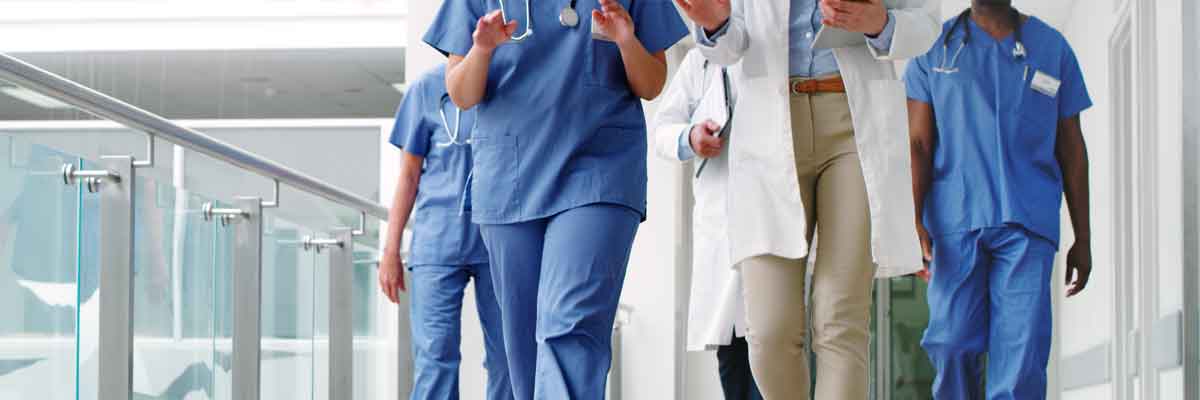 Hospital Key Management Cropped shot of a diverse group of unrecognizable medical practitioners walking in the hallway of a hospital.